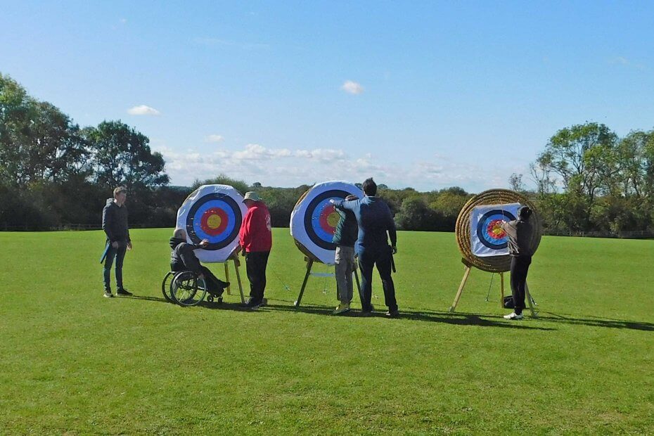 Beginner archers collecting their arrows from the boss